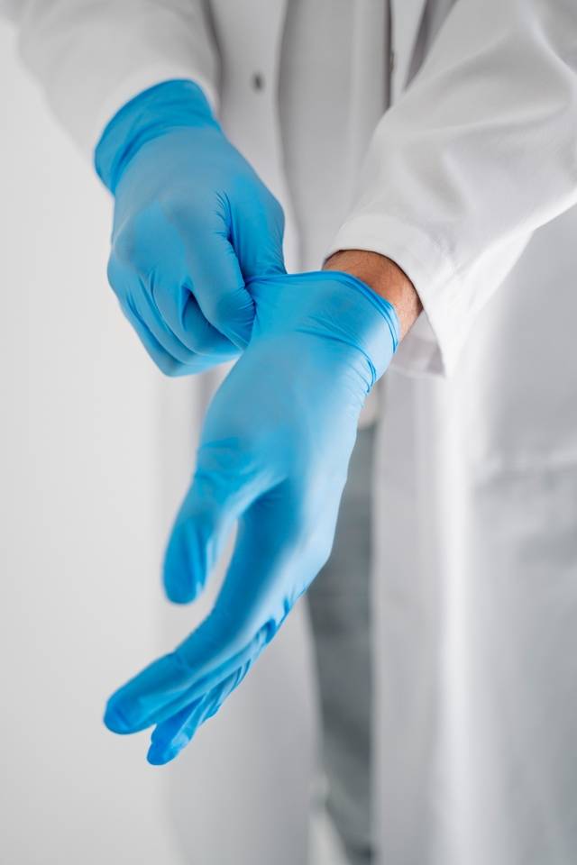 high-angle-doctor-putting-gloves